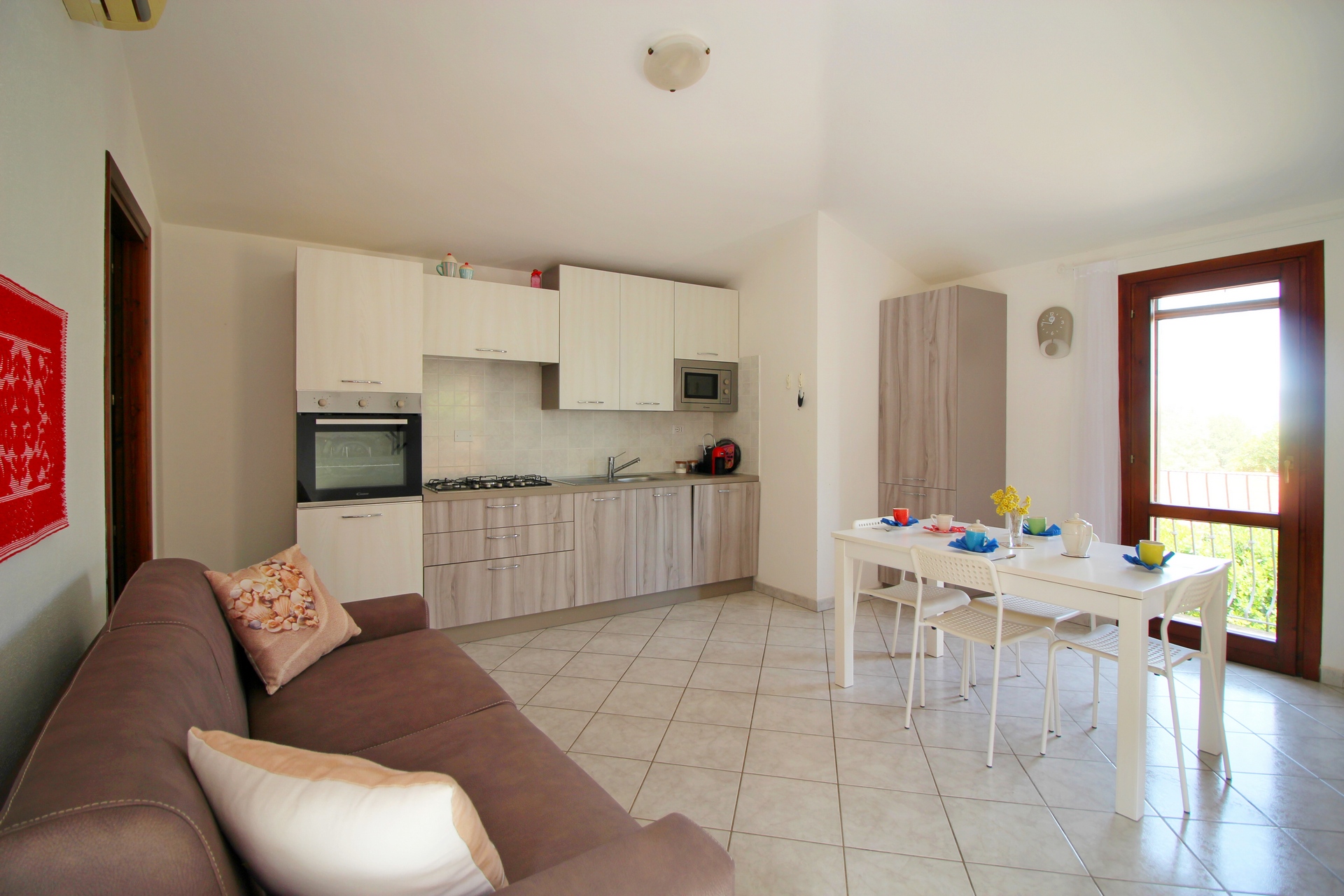 Zona giorno con cucina integrata a Domus Petrae